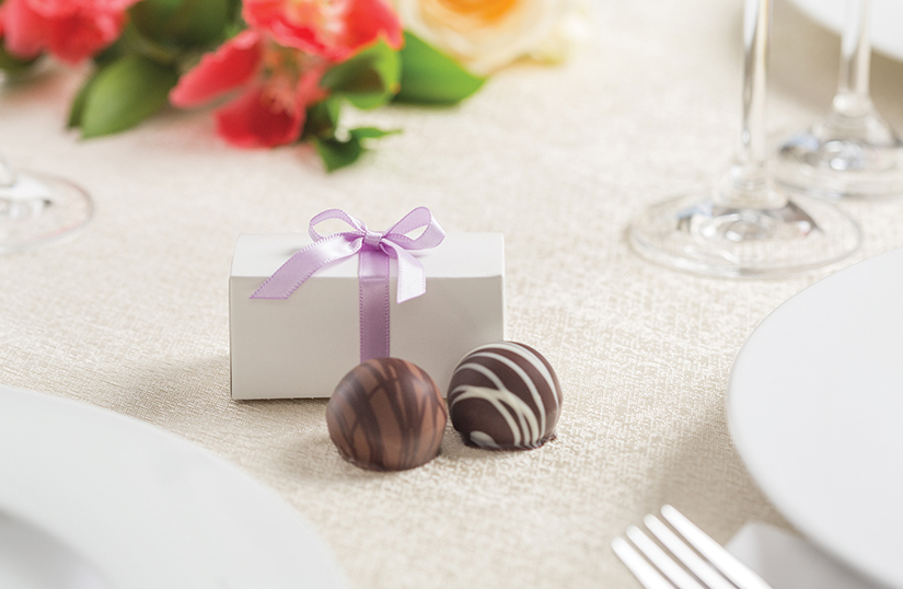 a chocolate fovor shown with a lilac ribbon